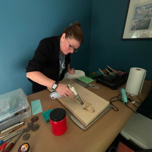 Laura Painting in a Blue Room with a Torch